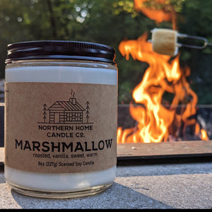 
                  
                    Load image into Gallery viewer, 8 Ounce Soy Candle in Clear Jar with Brown Northern Home Candle Company label that reads marshmallow. Fire and roasted marshmallow in the background.
                  
                