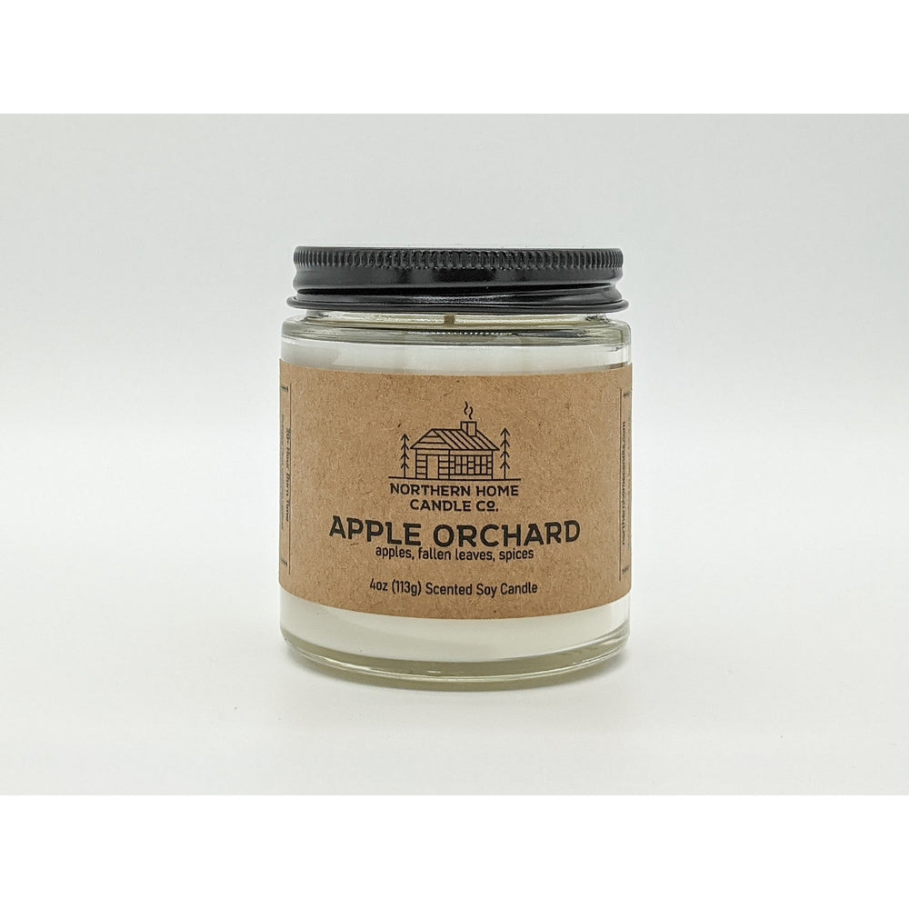 
                  
                    Load image into Gallery viewer, Soy candle with brown label that reads northern home candle and apple orchard surrounded by a white background. 
                  
                
