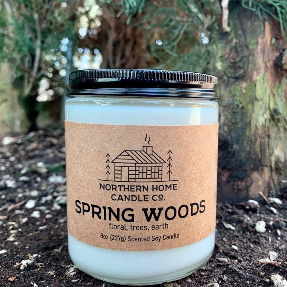 A Spring Woods candle from Northern Home Candle Company. Trees are in the background. Spring woods has notes of trees, flowers, and earth. 